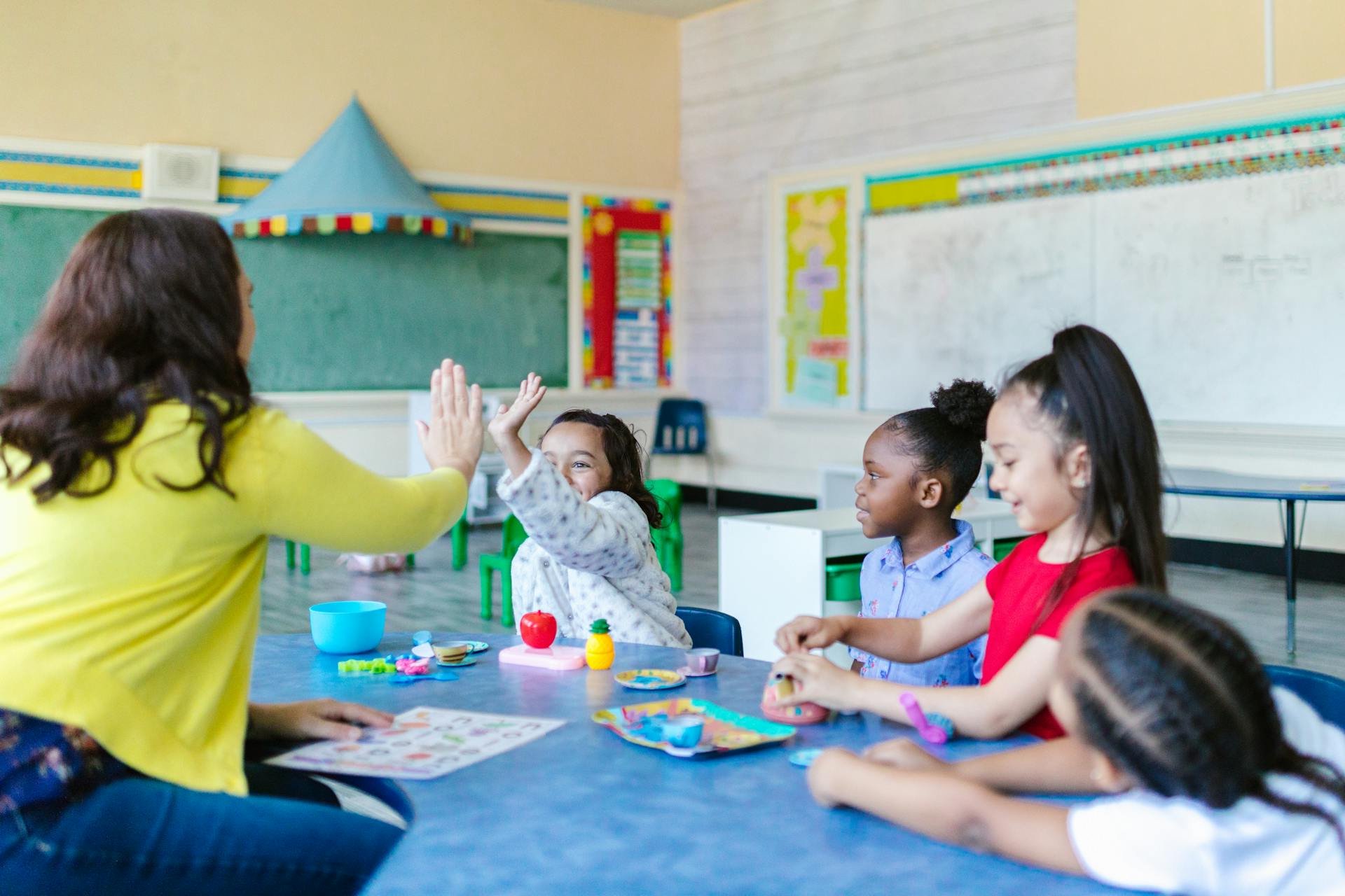 Caregiver reading to children in daycare setting